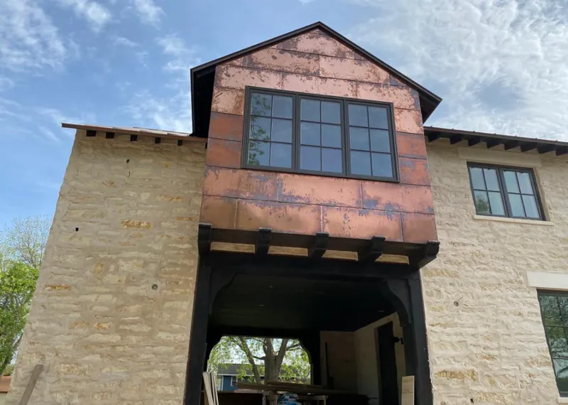 Copper metal panel facade on a stone building for Skylight Installation in Maumelle